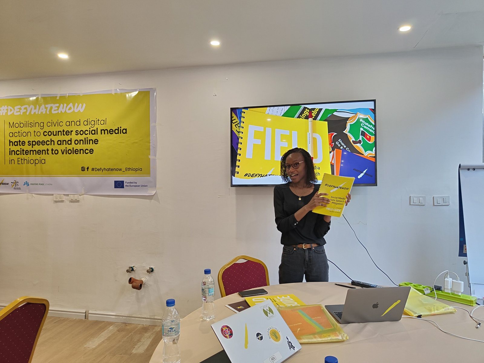Kendi Gikunda presenting the #defyhatenow field guide at a training session